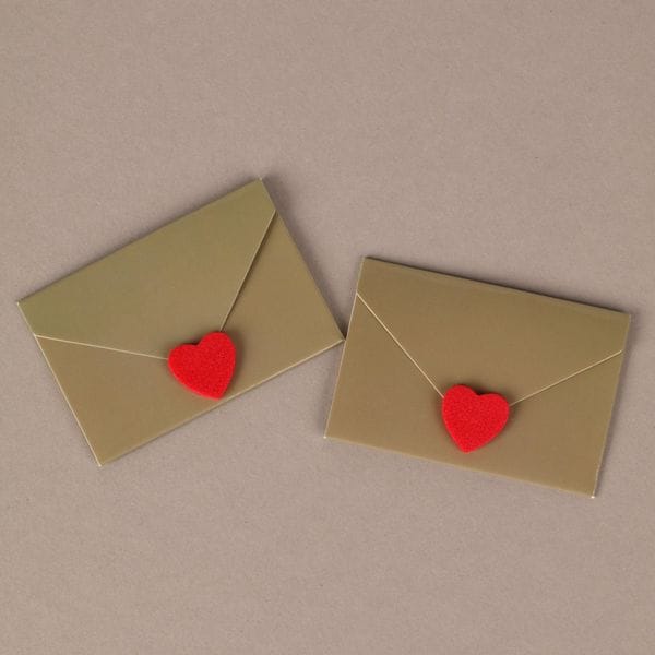 Two small envelopes, each sealed with a red heart